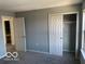 Bedroom with neutral walls, carpeted floors, an open doorway and open closet at 480 Village Blvd, Mooresville, IN 46158