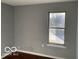 Bedroom features hardwood floors, a window letting in natural light and neutral walls at 480 Village Blvd, Mooresville, IN 46158