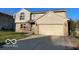 Charming two-story home featuring a two-car garage, brick accents, and well-maintained landscaping at 480 Village Blvd, Mooresville, IN 46158
