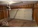 This is an empty garage with unfinished walls and a garage door at 480 Village Blvd, Mooresville, IN 46158