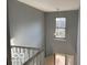 Hallway featuring staircase with white railings and neutral walls at 480 Village Blvd, Mooresville, IN 46158