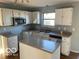 Bright kitchen with white cabinets, stainless appliances, and kitchen island at 480 Village Blvd, Mooresville, IN 46158