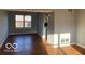 Sunlit living room featuring hardwood floors and a large window at 480 Village Blvd, Mooresville, IN 46158