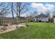 View of a lawn in a backyard with a fence, a patio and some trees at 4815 Winthrop Ave, Indianapolis, IN 46205
