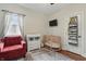 Cozy bedroom with crib, changing table, and comfortable red chair at 4815 Winthrop Ave, Indianapolis, IN 46205