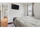Cozy bedroom with hardwood flooring and a comfortable queen bed at 4815 Winthrop Ave, Indianapolis, IN 46205