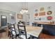 Spacious dining area featuring a wooden table, decorative wall art, and unique lighting fixture at 4815 Winthrop Ave, Indianapolis, IN 46205