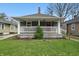 Charming home featuring a cozy front porch, well-maintained lawn, and inviting curb appeal at 4815 Winthrop Ave, Indianapolis, IN 46205