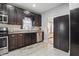 Functional kitchen features dark cabinets, stainless steel appliances, and tile flooring at 4815 Winthrop Ave, Indianapolis, IN 46205