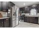 Spacious kitchen with stainless steel refrigerator, dark cabinetry, and ample counter space at 4815 Winthrop Ave, Indianapolis, IN 46205