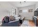 Bright living room with large windows, a comfortable sectional sofa, and contemporary decor at 4815 Winthrop Ave, Indianapolis, IN 46205