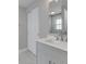 Bathroom vanity with grey cabinets, white countertop, and sliding closet doors at 4945 Camden St, Indianapolis, IN 46227