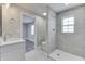 Modern bathroom with tile shower, floating vanity, and view to bedroom at 4945 Camden St, Indianapolis, IN 46227