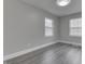 Bedroom with natural light from two windows and modern gray wood-look flooring at 4945 Camden St, Indianapolis, IN 46227