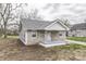 Quaint home featuring stone accents, vinyl siding, and a charming front porch area at 4945 Camden St, Indianapolis, IN 46227