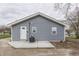 Exterior of home featuring gray vinyl siding, a concrete patio, and backyard views at 4945 Camden St, Indianapolis, IN 46227