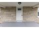 A welcoming front door with stone accents and a charming porch area at 4945 Camden St, Indianapolis, IN 46227