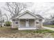 Charming stone home with a front porch and gray accents, offering a welcoming facade at 4945 Camden St, Indianapolis, IN 46227