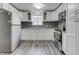 Bright kitchen with white cabinets, stainless appliances, and gray mosaic backsplash at 4945 Camden St, Indianapolis, IN 46227