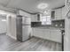 Bright kitchen with white cabinets, stainless appliances, and gray mosaic backsplash at 4945 Camden St, Indianapolis, IN 46227