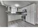 Bright kitchen with white cabinets, stainless appliances, and gray mosaic backsplash at 4945 Camden St, Indianapolis, IN 46227