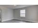 Bright living room with neutral walls and gray hardwood floors at 4945 Camden St, Indianapolis, IN 46227