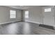 A well-lit living room featuring stylish gray hardwood floors and modern recessed lighting at 4945 Camden St, Indianapolis, IN 46227