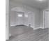 Bright living room with arched entryway, white trim, and gray wood-look flooring at 4945 Camden St, Indianapolis, IN 46227