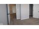 A neutral bedroom with carpet, white doors, and view to other rooms from the doorway at 4952 Cinnabar Trl, Brownsburg, IN 46112