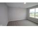 This bedroom has neutral walls and carpet with a view from the window at 4952 Cinnabar Trl, Brownsburg, IN 46112