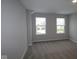 Bright bedroom featuring a large window, neutral walls, carpeted floors, and ample natural light at 4952 Cinnabar Trl, Brownsburg, IN 46112