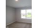 This bedroom has neutral walls and carpet with a view from the window at 4952 Cinnabar Trl, Brownsburg, IN 46112