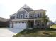 Beautiful two-story home featuring stone and shingle siding, a two-car garage, and a well-manicured lawn at 4952 Cinnabar Trl, Brownsburg, IN 46112