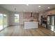 Modern kitchen with stainless steel appliances, a center island, light gray cabinets, and hardwood floors at 4952 Cinnabar Trl, Brownsburg, IN 46112