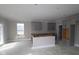Spacious kitchen featuring modern cabinetry, an island, and a view of the outdoor scenery at 4952 Cinnabar Trl, Brownsburg, IN 46112