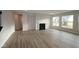 Inviting living room with a fireplace, hardwood floors, and large windows offering plenty of natural light at 4952 Cinnabar Trl, Brownsburg, IN 46112