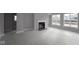 Bright living room with a modern fireplace and large windows offering plenty of natural light at 4952 Cinnabar Trl, Brownsburg, IN 46112