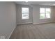 This living room has neutral walls and carpet with views from two windows at 4952 Cinnabar Trl, Brownsburg, IN 46112