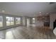 Bright and spacious living room with hardwood floors, large windows, and an open floor plan to the kitchen at 4952 Cinnabar Trl, Brownsburg, IN 46112