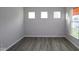 Cozy room perfect for an office featuring neutral walls, hardwood floors, baseboards, and natural light at 4952 Cinnabar Trl, Brownsburg, IN 46112