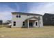 The back of this two-story home features gray siding, multiple windows, and a covered patio with sliding glass doors at 4960 Cinnabar Trl, Brownsburg, IN 46112