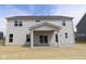 Two-story home featuring gray siding, multiple windows, and a covered patio with sliding glass doors at 4960 Cinnabar Trl, Brownsburg, IN 46112