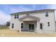 Back exterior view of a two-story home with gray siding, windows, and a covered patio leading to the backyard at 4960 Cinnabar Trl, Brownsburg, IN 46112