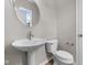 Well-lit powder room with modern fixtures, pedestal sink, and neutral paint at 4960 Cinnabar Trl, Brownsburg, IN 46112