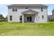 Back of home featuring sliding glass doors to covered patio overlooking grassy backyard at 4960 Cinnabar Trl, Brownsburg, IN 46112