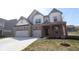 Charming two-story home with brick accents, a three-car garage, and a well-manicured lawn at 4960 Cinnabar Trl, Brownsburg, IN 46112