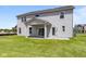 Backyard view of two-story home featuring sliding doors to a covered patio at 4960 Cinnabar Trl, Brownsburg, IN 46112