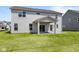 Rear exterior view highlighting a covered patio and spacious backyard at 4960 Cinnabar Trl, Brownsburg, IN 46112