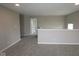 The hallway features neutral walls, carpet flooring, and a half wall looking into another room at 4960 Cinnabar Trl, Brownsburg, IN 46112