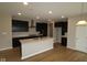 Modern kitchen with stainless steel appliances, a large center island, and dark wood cabinetry at 4960 Cinnabar Trl, Brownsburg, IN 46112